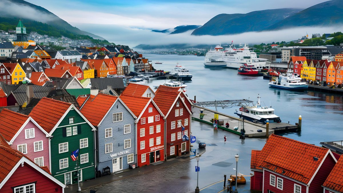 Colorful wooden houses in Bergen&#x27;s harbor with ships and fjords in the background
