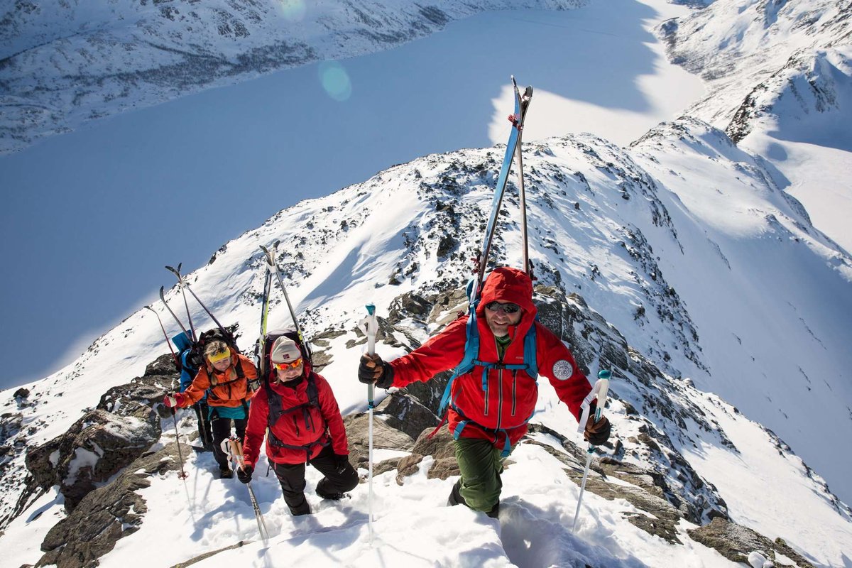 A group of climbers ascends to the Styggebreen glacier along a snowy ridge.