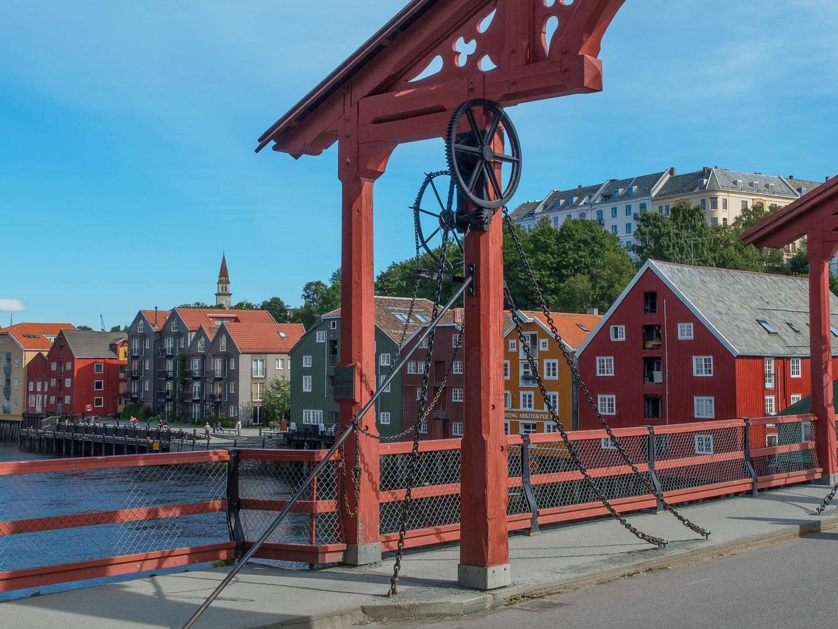 View of the historic bridge and colorful houses in the Bakklandet district of Trondheim.