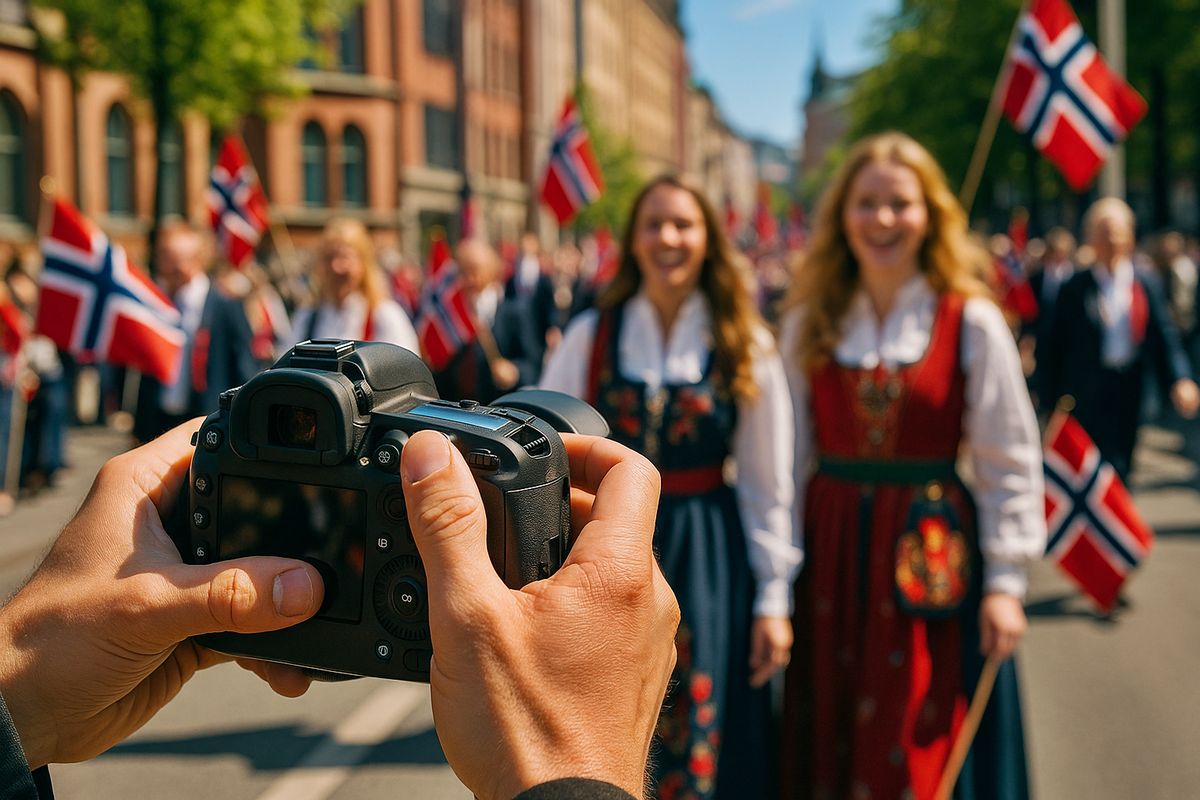 A person photographs parade participants with Norwegian flags through the camera lens.