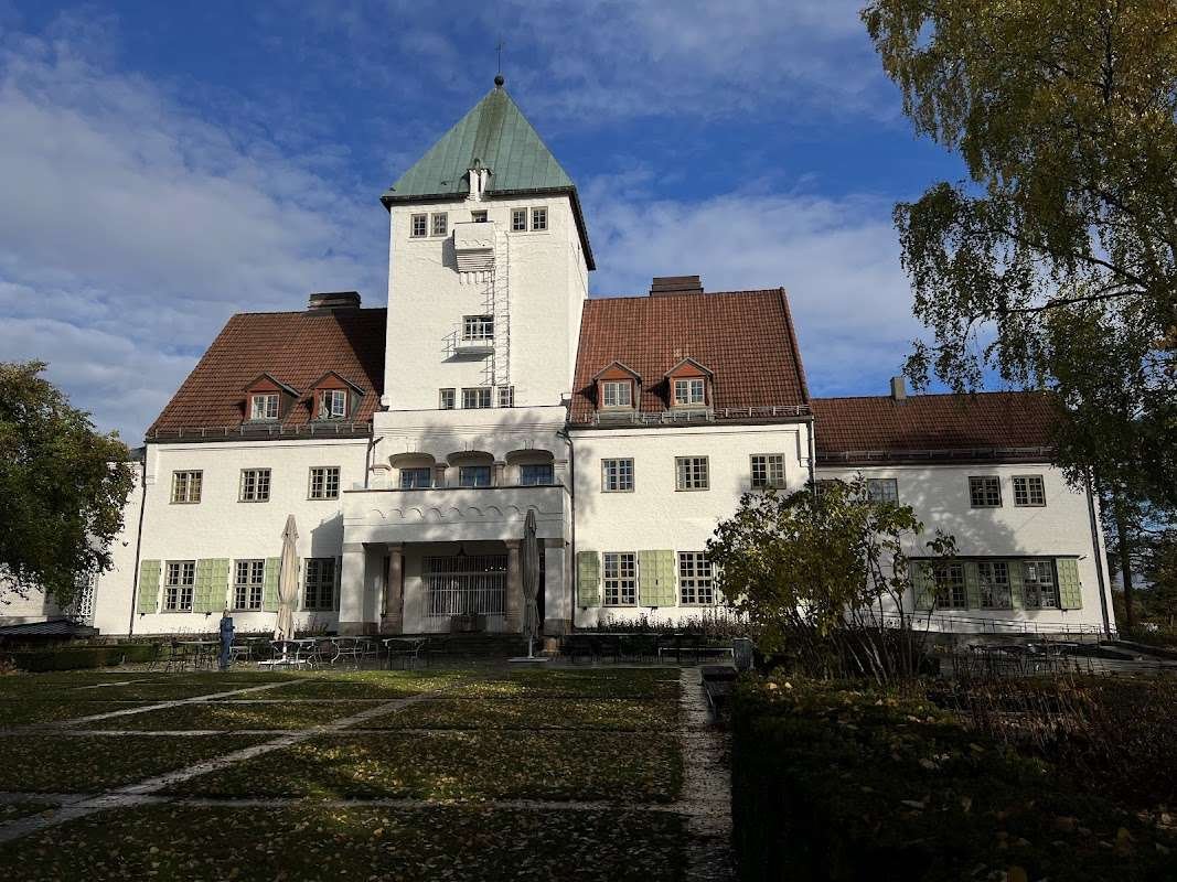 The Center for Studies of the Holocaust and Religious Minorities in Oslo, located in a historic building with a red roof and tower.