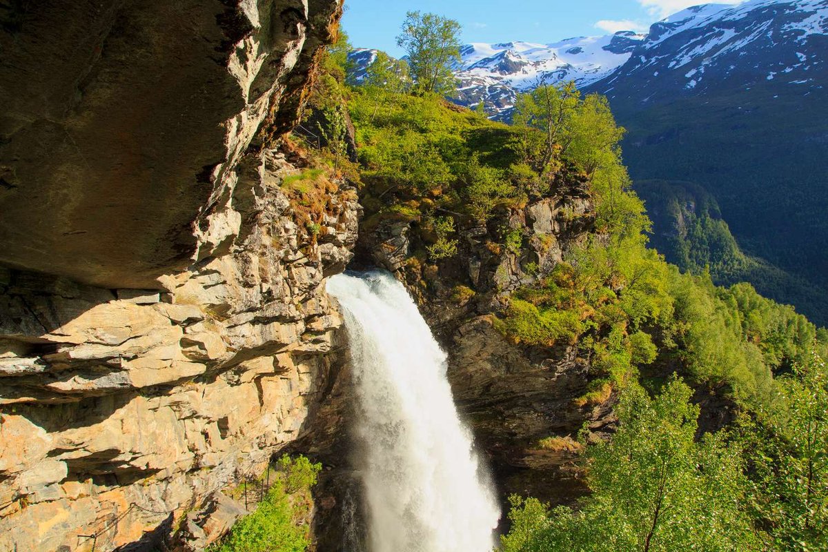 The trail to Storseterfossen Waterfall allows visitors to walk behind the water curtain.