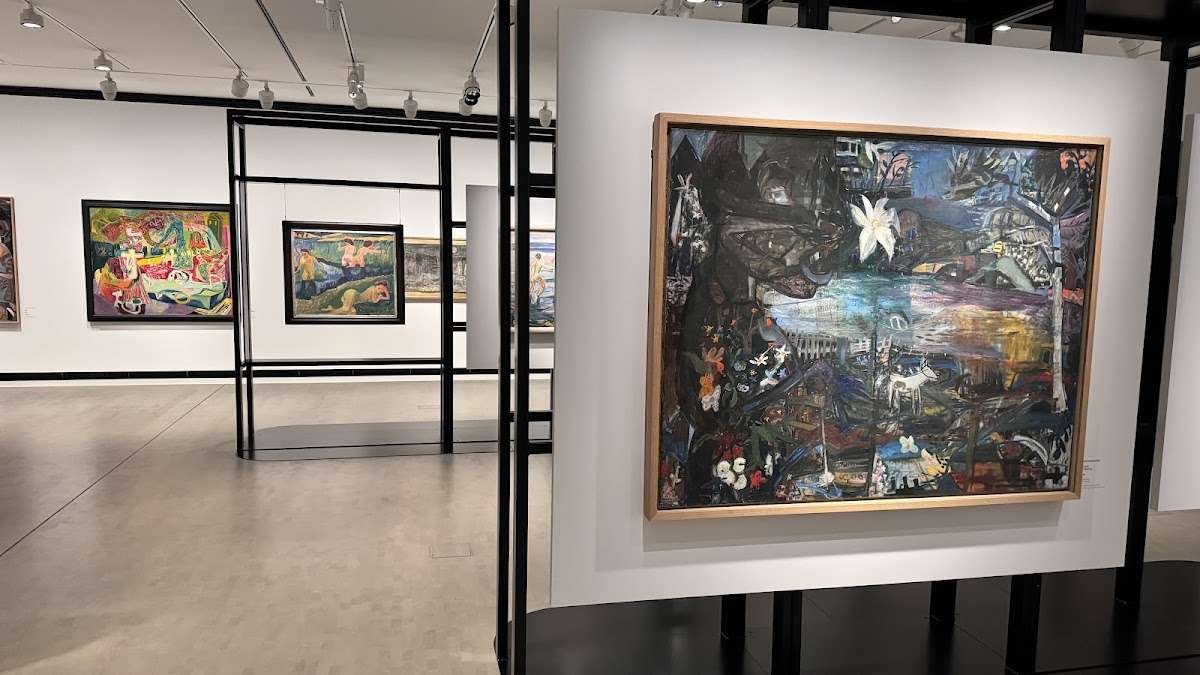 A modern exhibition space at the MUNCH Museum in Oslo with vibrant paintings and diverse artistic compositions.