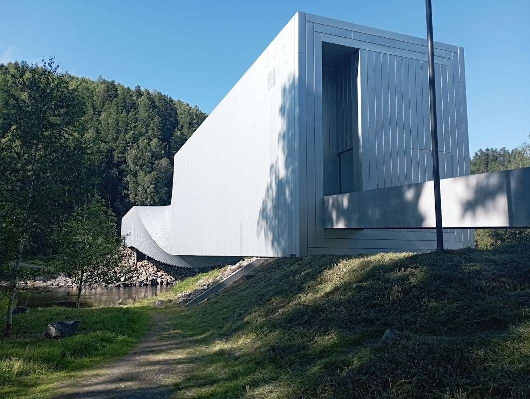 The architectural masterpiece The Twist with flowing shapes set against a green forest and blue sky.