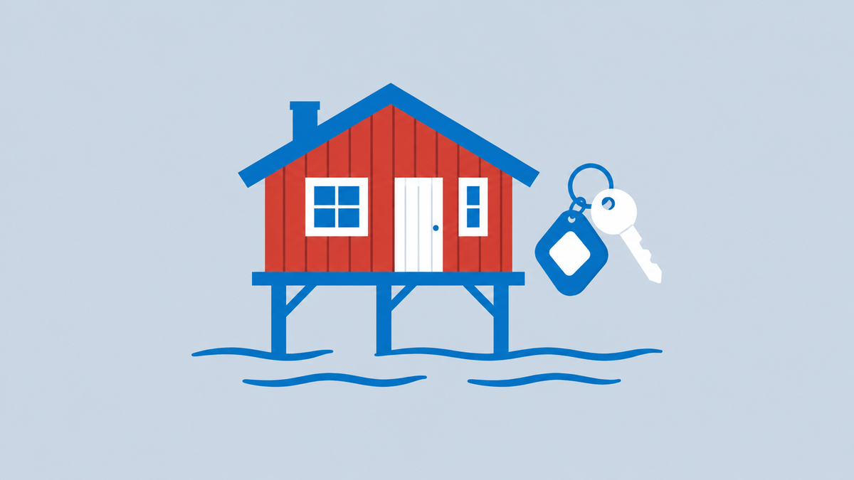 a red wooden cabin on stilts by calm water with a small hotel key tag floating beside it