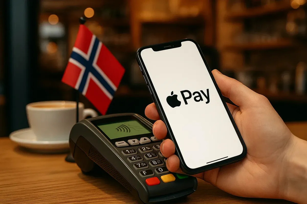 A smartphone displaying Apple Pay being used at a payment terminal in a Norwegian café.