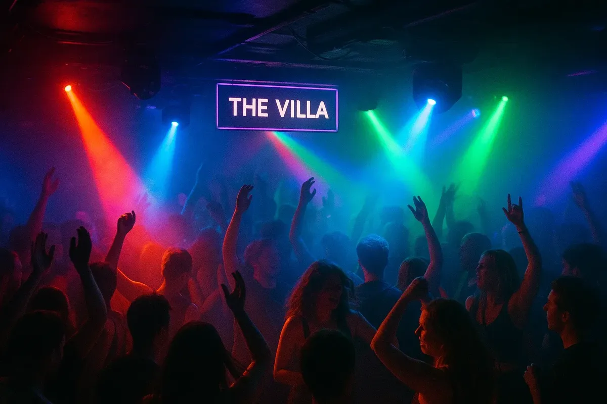 Energetic dance floor at The Villa in Oslo with electronic music, colorful lighting, and packed crowd